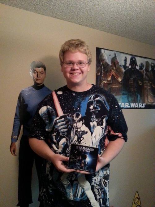 Jake holds his signed copy of the award-winning soundtrack Starship Rising