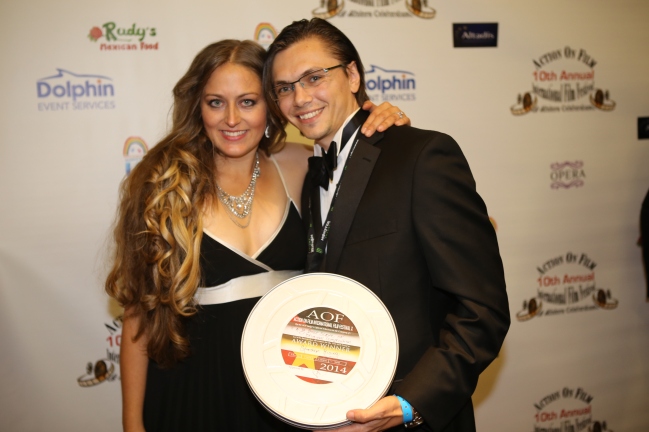 Jennifer and Charles-Henri Avelange holding the Best Music Score Award on the Red Carpet